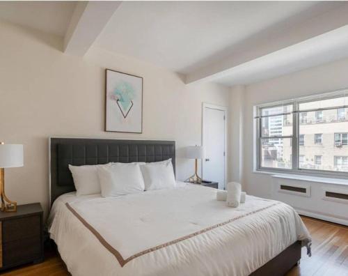 a bedroom with a large bed and a window at Lovely 4 BR in NYC! in New York