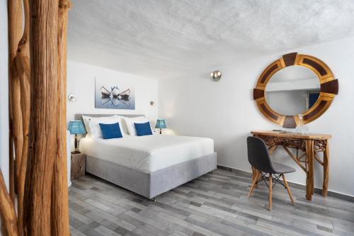 1 dormitorio con cama, espejo y silla en Skinopi Fisherman's Dream, en Schinopi