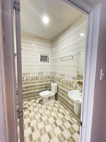 a bathroom with a toilet and a sink at Phuong Vy 2 in Da Lat