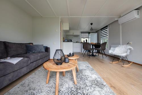 a living room with a couch and a table at 37, located in a quiet & wooded area! in Oisterwijk