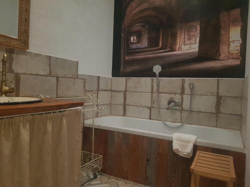 a bathroom with a bath tub and a sink at Ehemalige Schmiede -Dormitorium- in Ochsenhausen