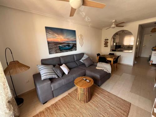 a living room with a couch and a table at Estrella in Mar de Cristal