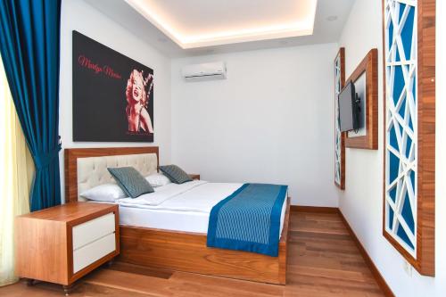 a small bedroom with a bed and a tv at New Chill and Go Apartments in Budva