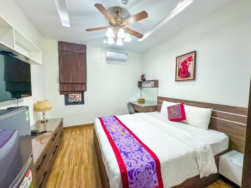 a bedroom with a bed and a ceiling fan at AVA Hotel & Apartment in Danang
