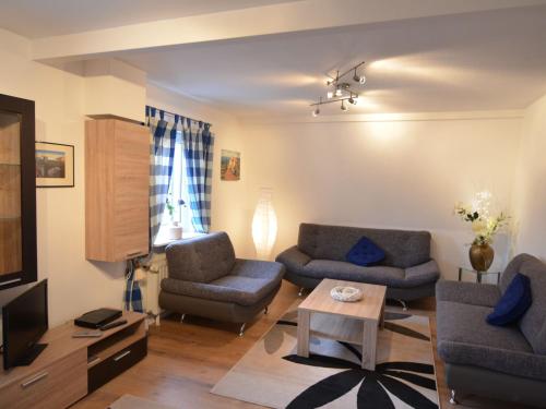 a living room with two couches and a tv at Wonderful Apartment in Elpe with Garden in Elpe