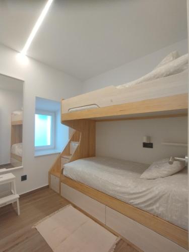 a bedroom with two bunk beds and a mirror at Casa Anton in Muxia