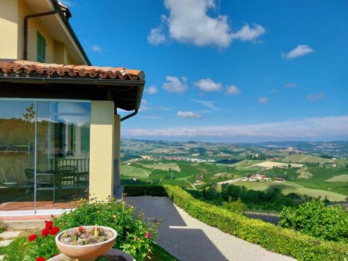a house with a balcony with a view of the valley at Villa Bellavista Alba, B&B in Alba
