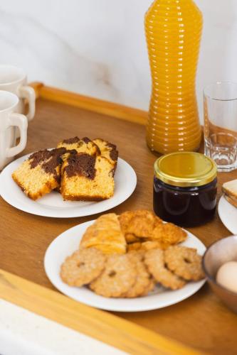 two plates of food on a table with cookies at Windmillside Luxury Villas in Emporio Santorini