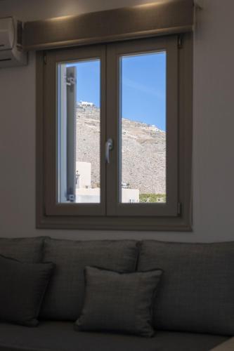 a window in a room with a couch in front at Windmillside Luxury Villas in Emporio Santorini