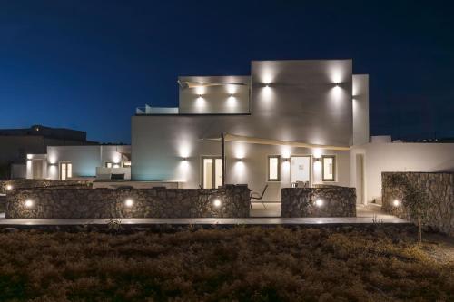 a house lit up at night with lights at Windmillside Luxury Villas in Emporio Santorini