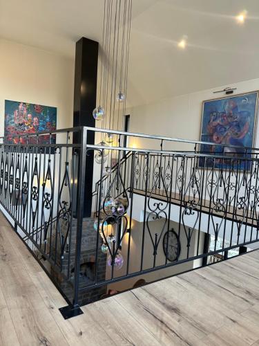 a staircase with a wrought iron railing in a building at Balkonum Luxury Guest House in Gosh