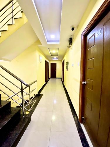 an empty hallway in a building with a door at Hotel Sky Park in Shamshabad