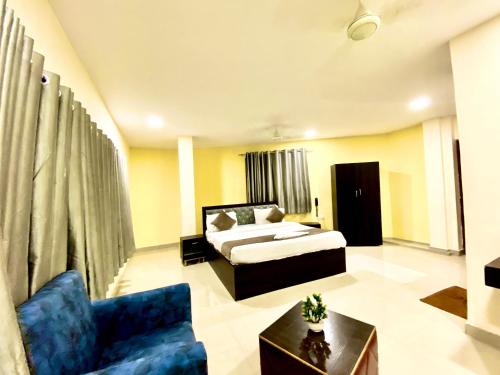 a hotel room with a bed and a couch at Hotel Sky Park in Shamshabad