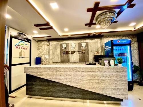 a bar in a restaurant with a drink counter at Hotel Sky Park in Shamshabad