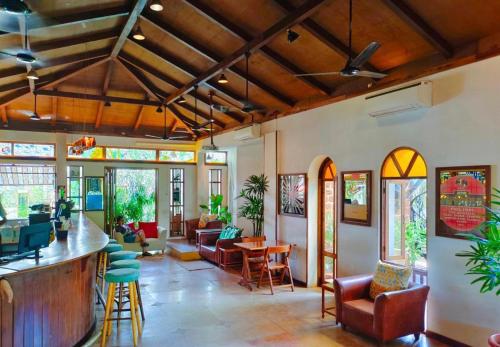 a living room with a bar and chairs at Cavala The Seaside Resort in Baga