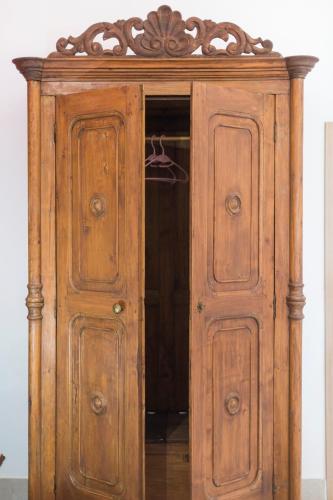 a wooden cabinet with two doors in a room at Villa Giulia - Vesuvio Guest House Pompei Sorrento in Boscotrecase