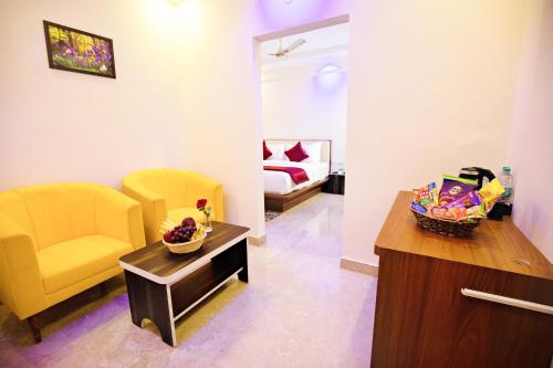 a living room with a couch and a chair and a table at Villa Grand Hotel Near Kempegowda International Airport in Bangalore