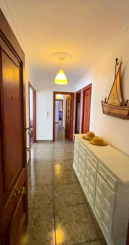 a hallway with a room with a counter and a boat on the wall at Vicedo Bay View in O Vicedo