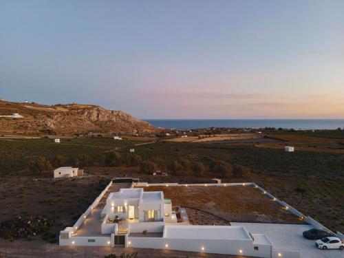 an aerial view of a white house in a field at Windmillside Luxury Villas in Emporio Santorini