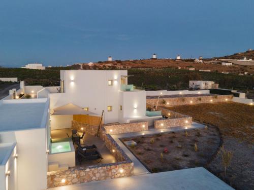 a view of a white house with lights at Windmillside Luxury Villas in Emporio Santorini