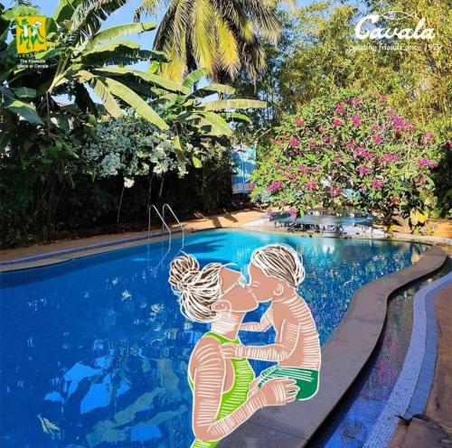 a picture of two children kissing by a swimming pool at Cavala The Seaside Resort in Baga
