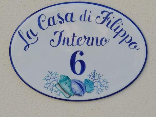 a sign that reads la casa de fiesta influenza at La Casa di Filippo in Quercianella