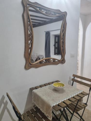 a table with a mirror and a bowl on it at Villa Olive Old Qeparo in Qeparo