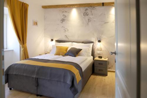 a bedroom with a bed and a wall with flowers at Vila Ulika in Malinska