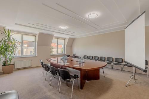 a conference room with a long table and chairs at Palace Del Mar in Odesa