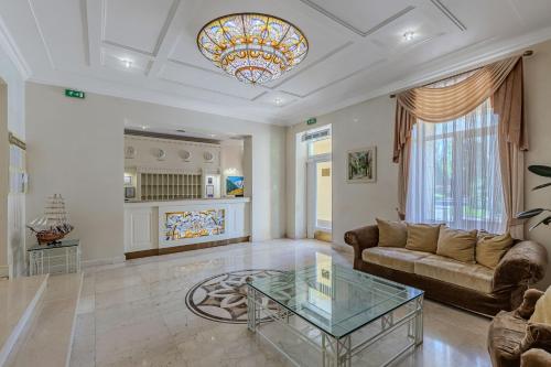 a living room with a couch and a glass table at Palace Del Mar in Odesa