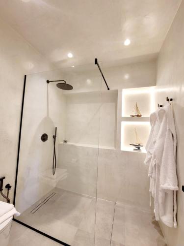 a bathroom with a shower with a glass door at Artis Blue Relax in Himare