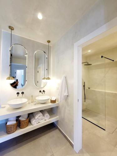 a bathroom with two sinks and a shower at Artis Blue Relax in Himare