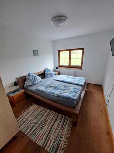 a bedroom with a large bed and a rug at APPARTEMENT Brix in Pichl