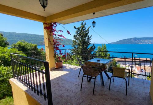 a patio with a table and chairs on a balcony at SeaView Zelenika in Herceg-Novi