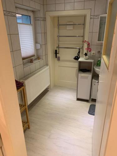 a small kitchen with a sink and a refrigerator at FeWo Meikoe in Lutherstadt Eisleben