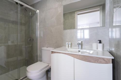 a bathroom with a toilet and a sink and a shower at Maria Pia Suite 3 in Porto