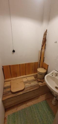 a bathroom with a toilet and a sink at Schwedisches Bauernhaus in Jörn