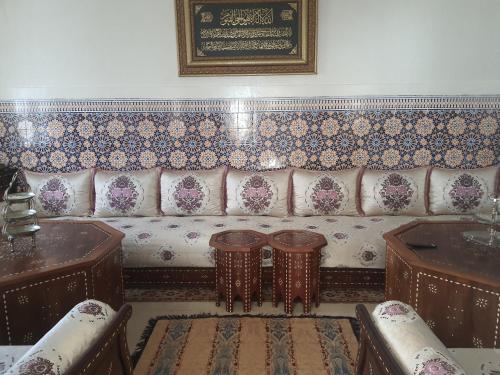 a living room with a couch and two tables at Marrakech plus in Marrakech