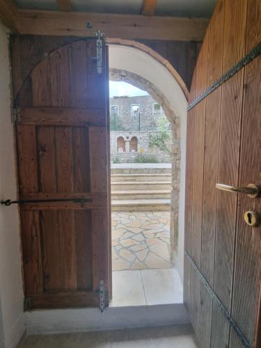 an entrance to a room with a wooden door at Villa Olive Old Qeparo in Qeparo