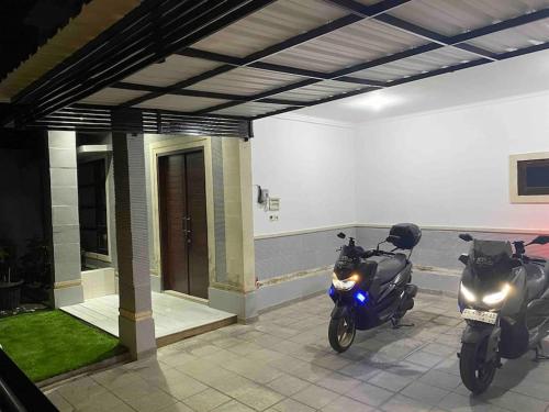 two motorcycles parked in front of a building at Villa Jessy near Canggu Seminyak Kuta in Denpasar