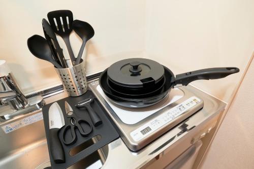 a stove top with a pot on top of it at Fiore Kinshicho by Tranova in Tokyo