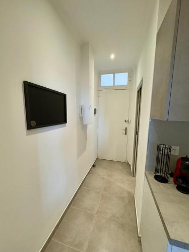 a hallway with a flat screen tv on a wall at Studio BeHappy next Monaco in Cap d'Ail