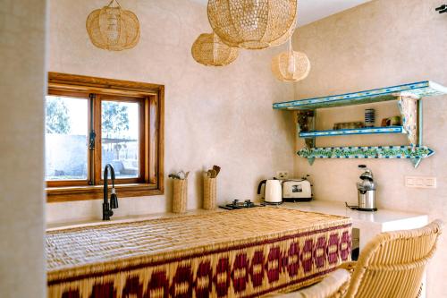 a kitchen with a counter and a sink and a counter top at Villa Madame Babouche, Studio Lahna, SdB privative in Oulad el Madani