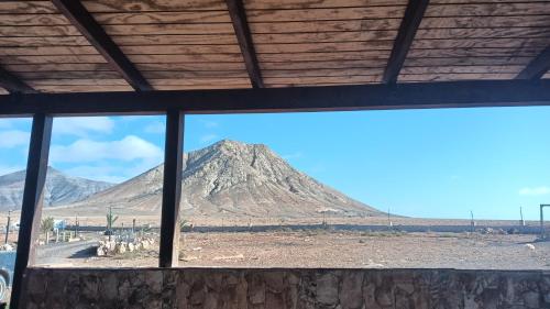 a view of a mountain from a window at Caravana Magic in Tindaya