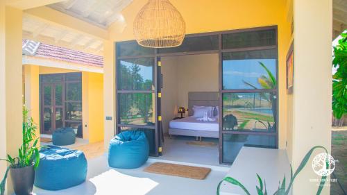 Postel nebo postele na pokoji v ubytování Nikara Beach Villas Arugambay