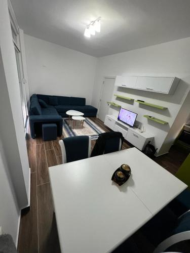 a living room with a white table and a couch at Djonis Apartment in Shëngjin