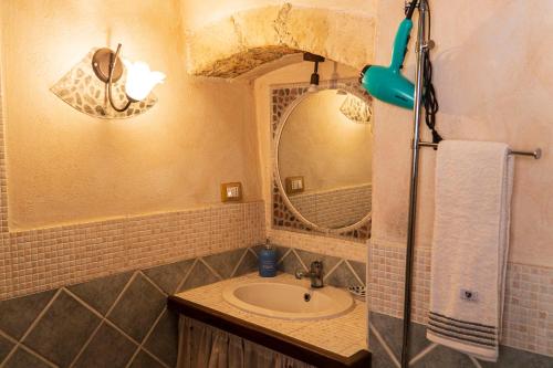 a bathroom with a sink and a mirror at Maria Guesthouse in Sassari