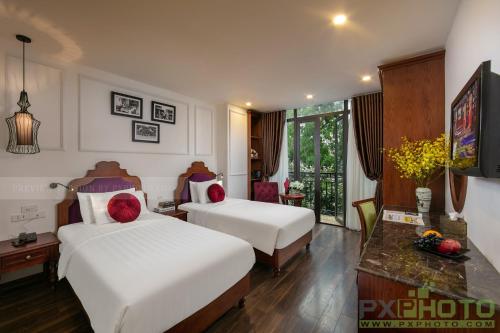 Postel nebo postele na pokoji v ubytování Vision Premier Hotel in Hanoi Central
