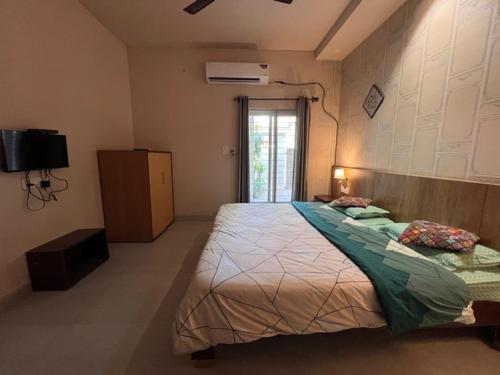 a bedroom with a large bed in a room at GREEN HOME STAY in Lucknow