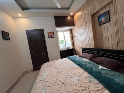 a bedroom with a large bed in a room at GREEN HOME STAY in Lucknow